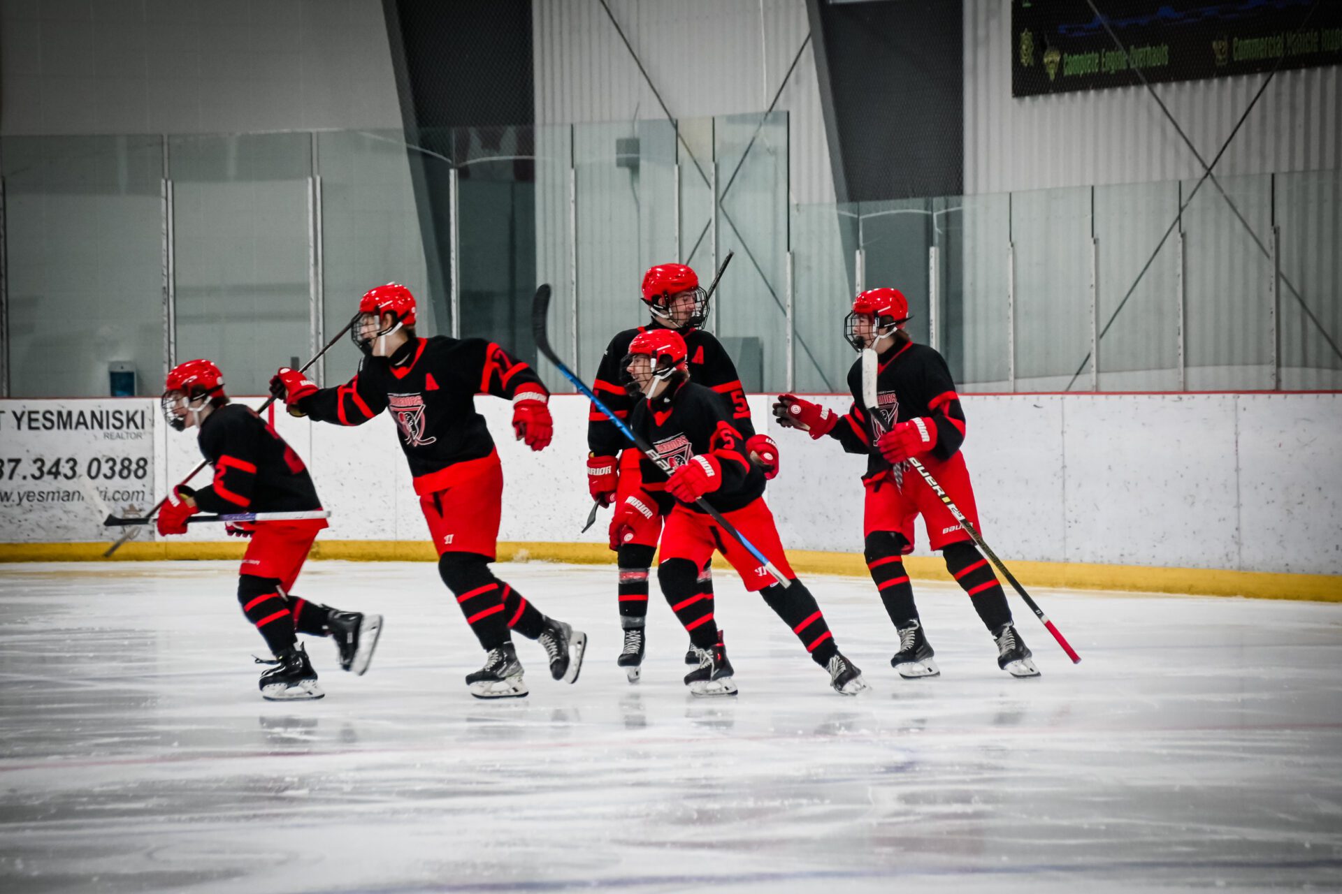 Hockey players skating on ice. 